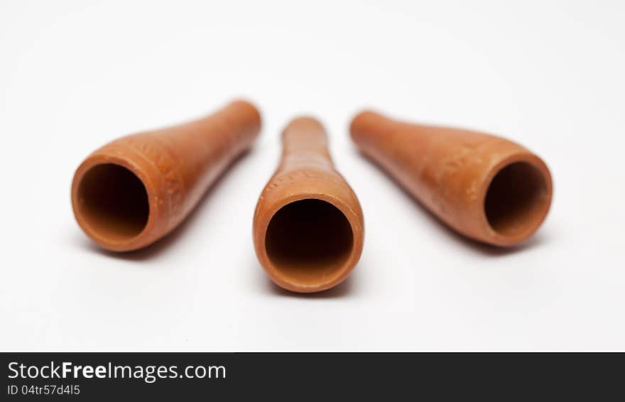 Hand made three smoking clay pipe on white background