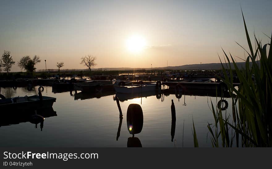 Fishing Boats at Lake in Sunset