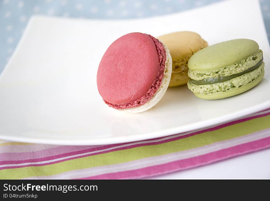 Colorful macarons put on colorful line background. Colorful macarons put on colorful line background