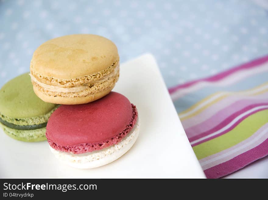 Sweet macarons on color line and polka dot background. Sweet macarons on color line and polka dot background