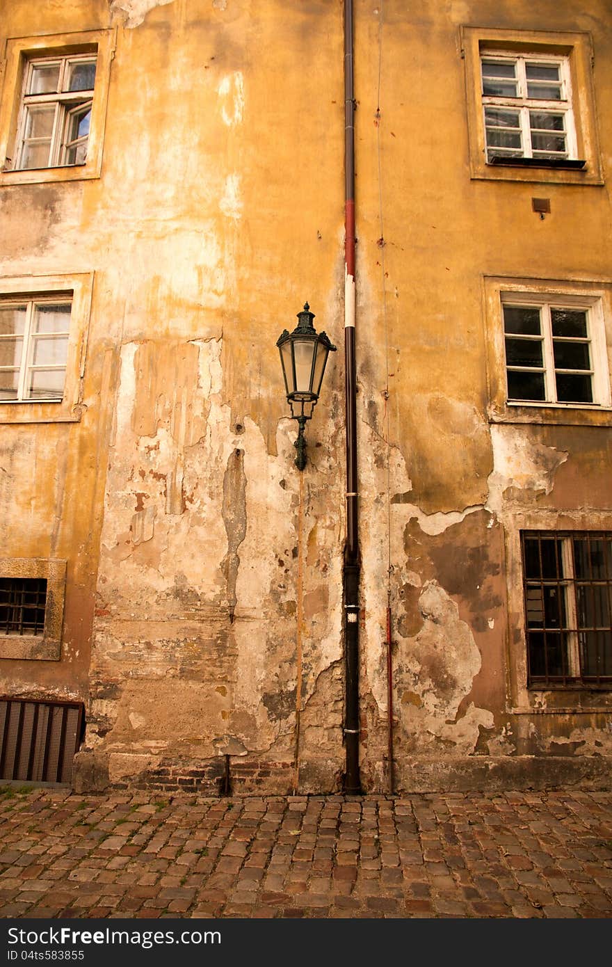 Yellow house wall with lamp and windows and plaster sink. Yellow house wall with lamp and windows and plaster sink