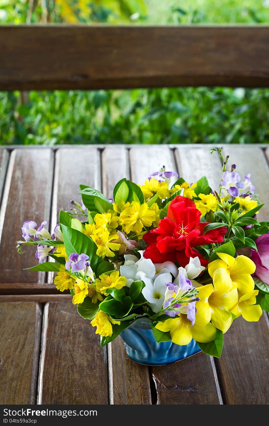 Flower bouquet on wood table in the garden. Flower bouquet on wood table in the garden