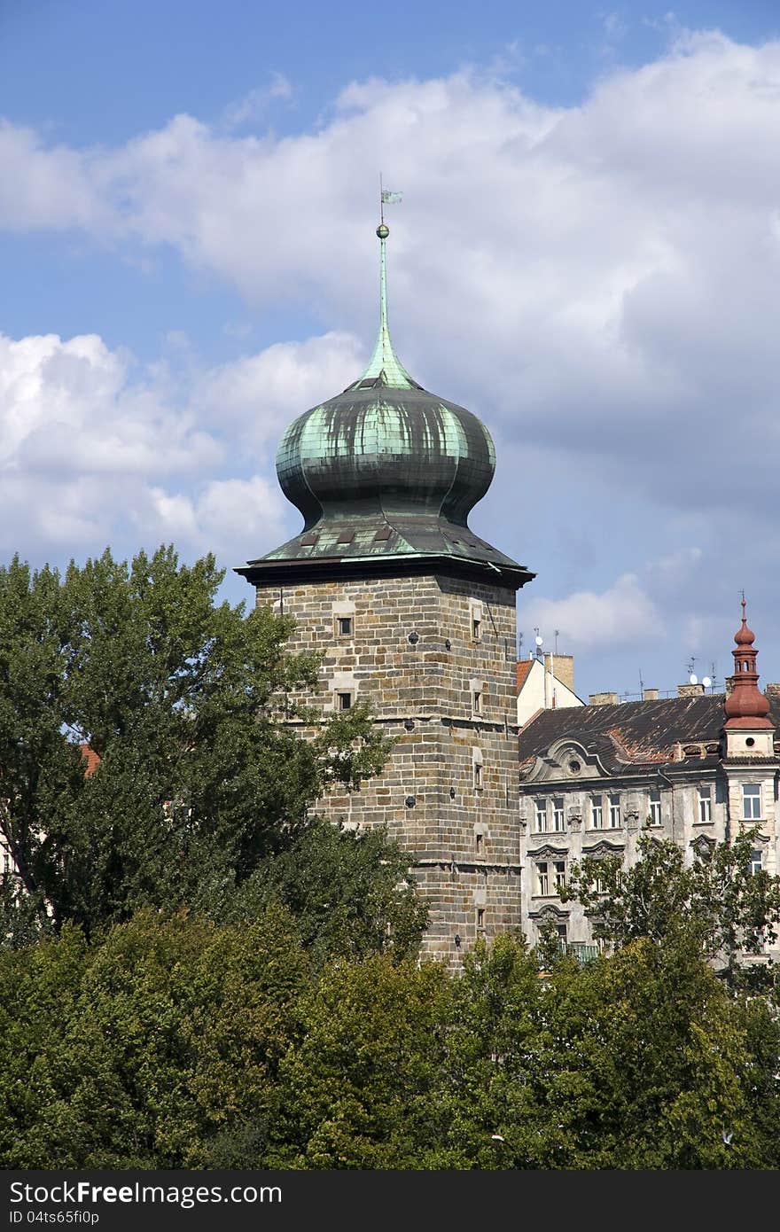 Tower manes between green trees in summer