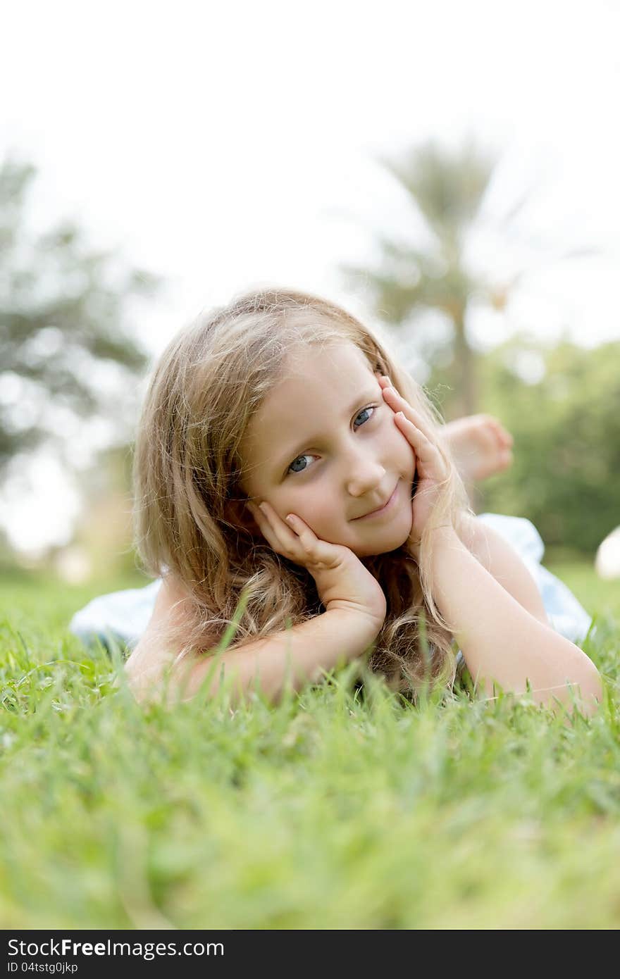 Pretty blond girl outdoors in summer day