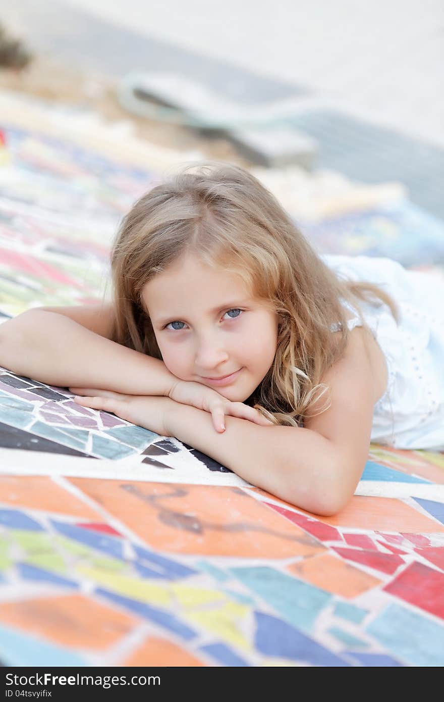 Portrait of a cute blond girl in summer day