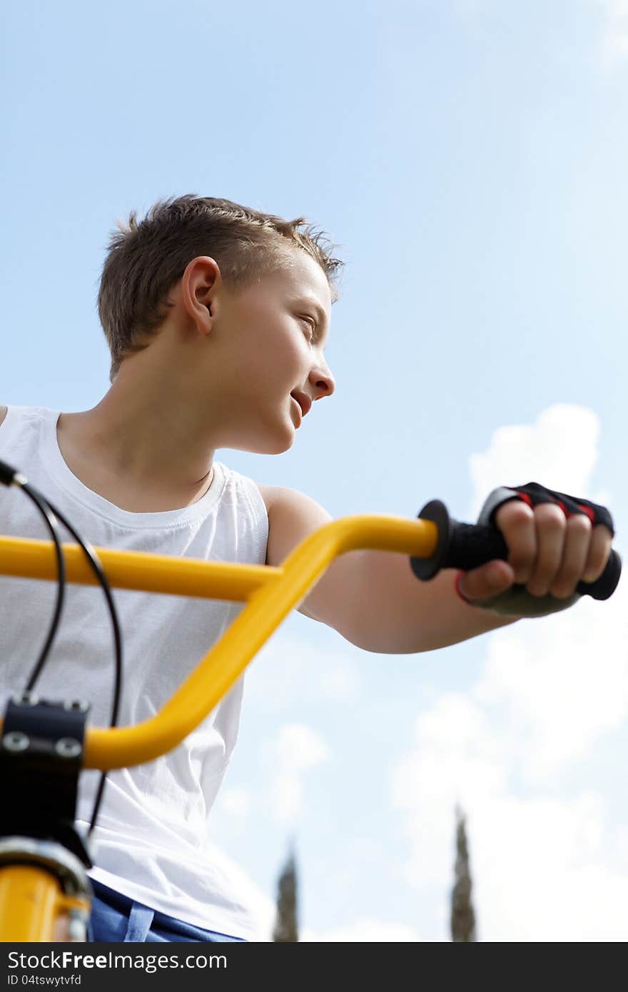 Cute guy on a bike outside in the summer day