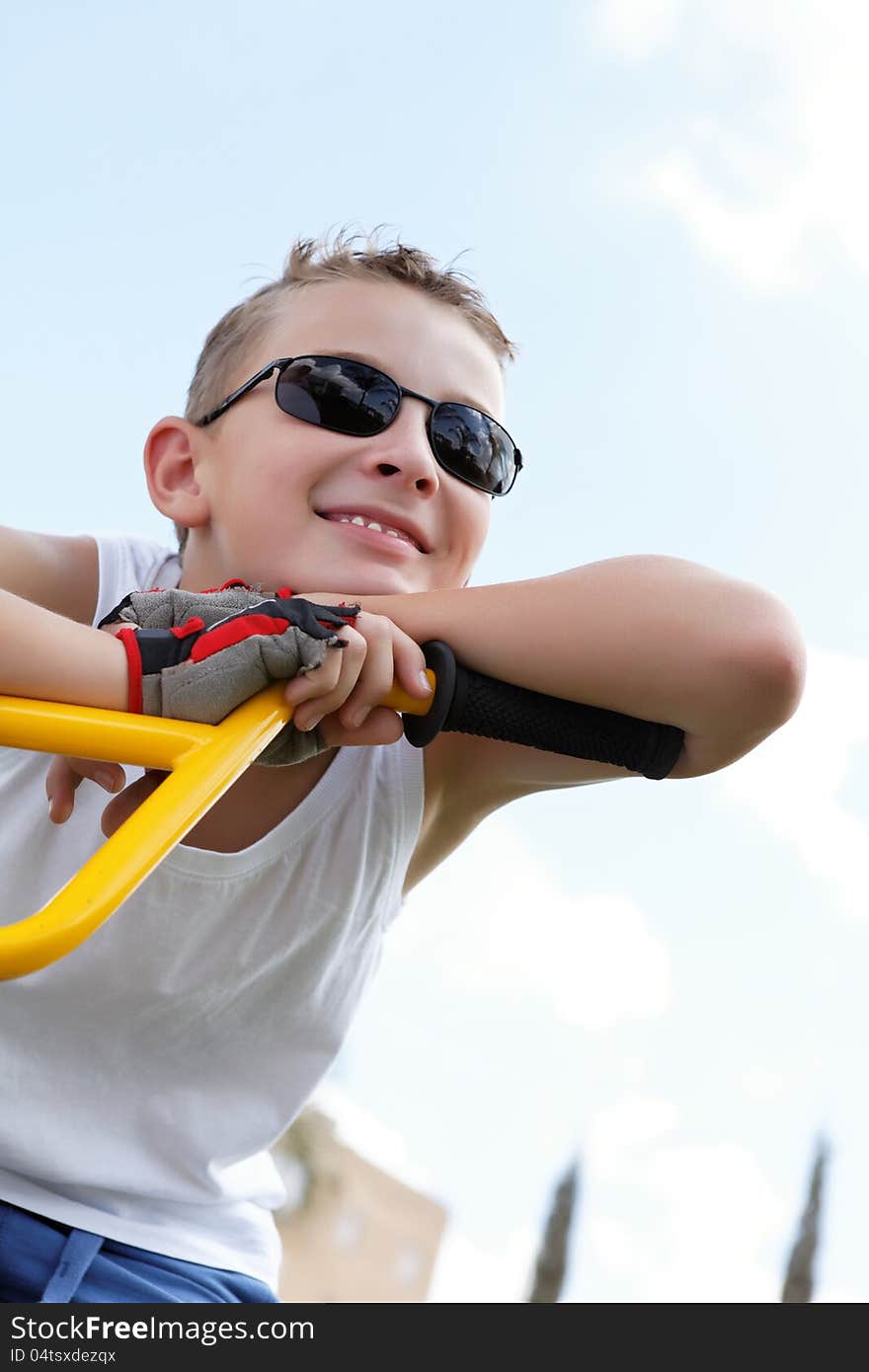 Boy on a bike outside in the summer day