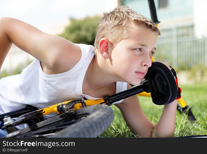 Sport boy and bike outside in the summer day