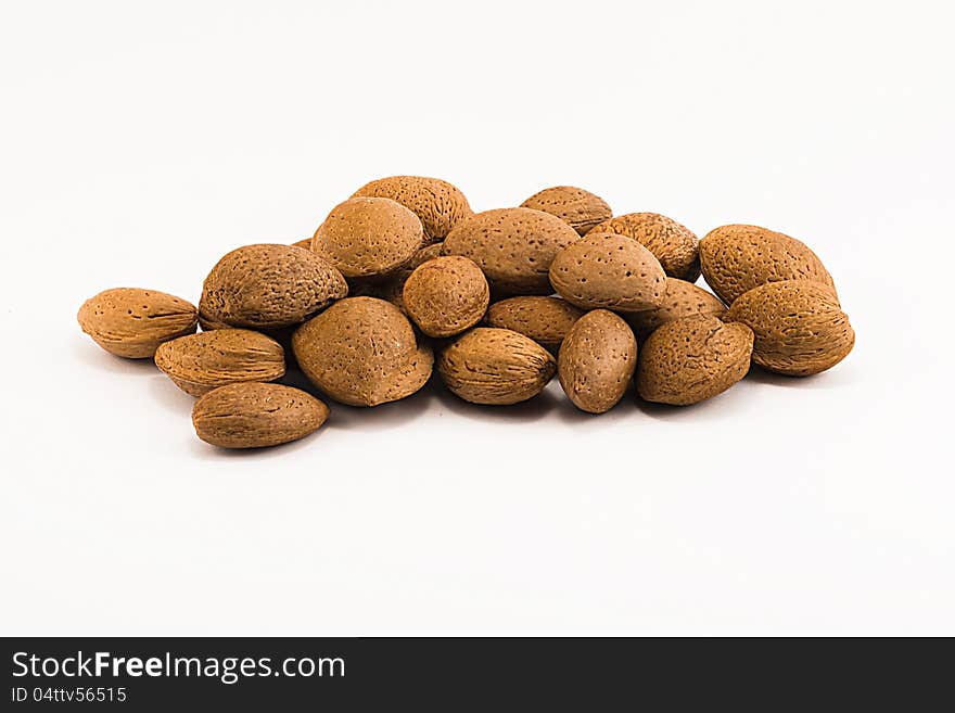 Almonds with rind on white background