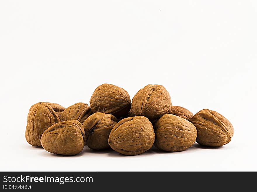 Nuts, ripe fruit of the walnut on white background.