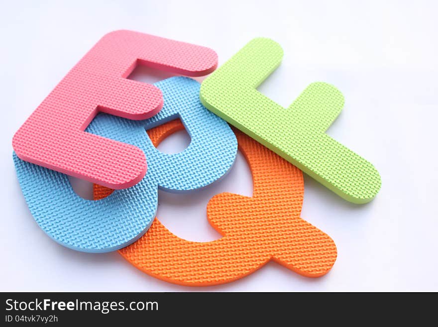 Pile of colorful letters on white background