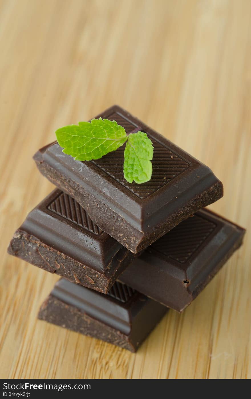 Slices of chocolate stacked with mint leaf. Slices of chocolate stacked with mint leaf