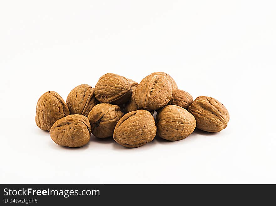 Nuts, ripe fruit of the walnut on white background.