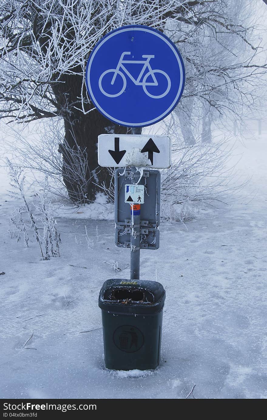 Traffic signs and waste-paper basket in frozen inundated Rijn area. Traffic signs and waste-paper basket in frozen inundated Rijn area