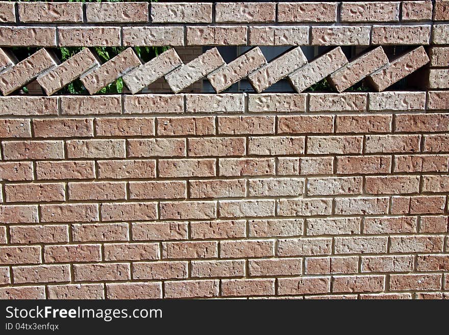 The row of textured bricks at an angle create a splendid ornamental patterned brick wall in this modern urban street scape. The row of textured bricks at an angle create a splendid ornamental patterned brick wall in this modern urban street scape.