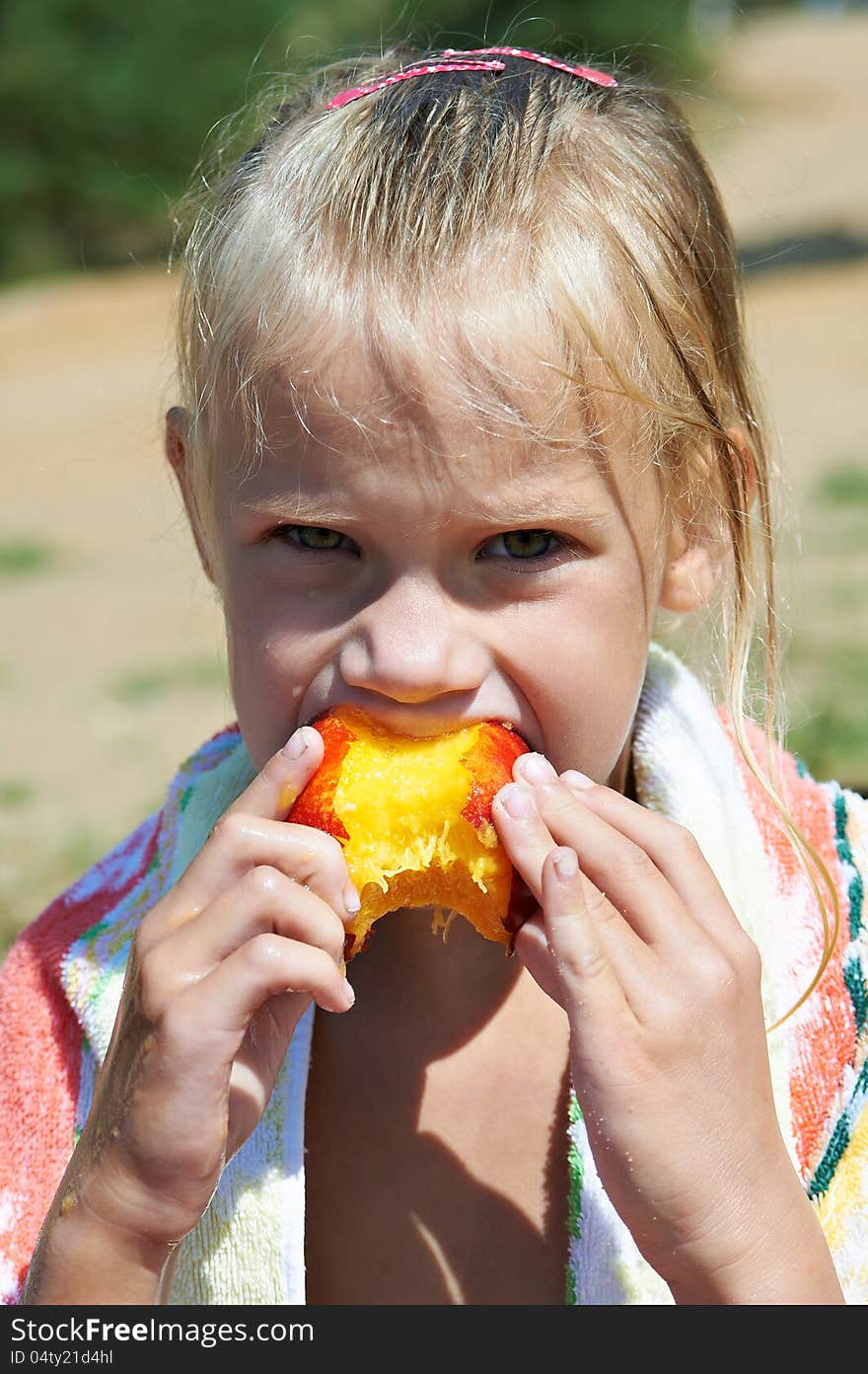 Little Girl Eating A Peach