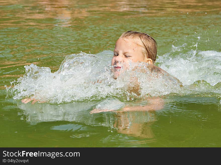 Little girl swimming in lake