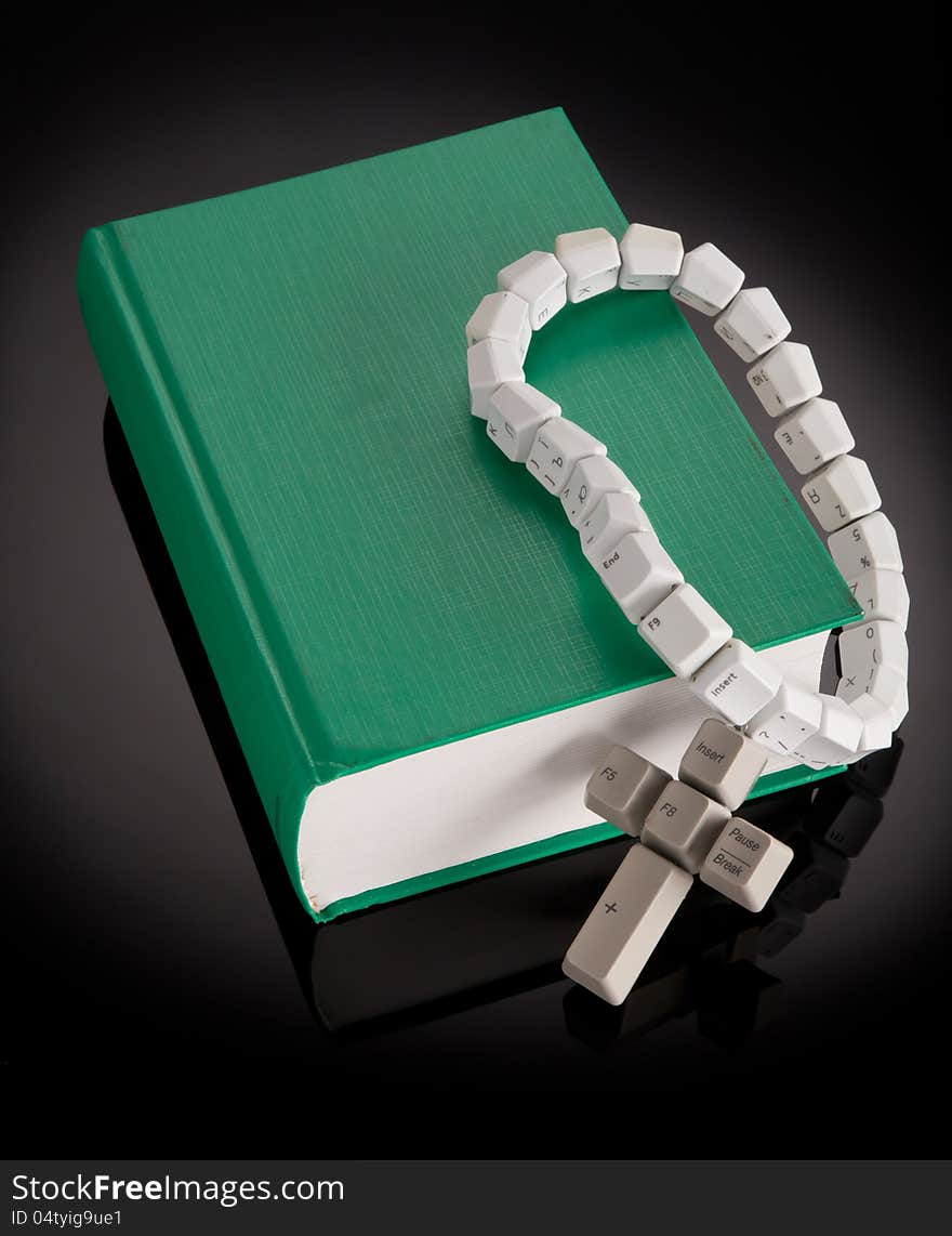 Christian, catholic rosary made from computer keyboard with green book