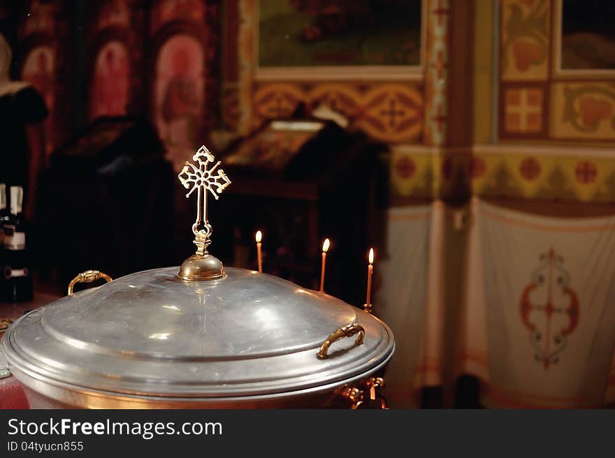 In the church against church paraphernalia candles next to the cross. In the church against church paraphernalia candles next to the cross