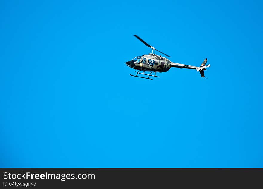 Camouflage Bell 206 helicopter flying