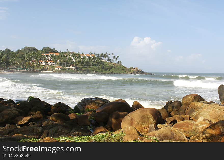 Beautiful beach surrounded by rocks in kovalam beach, india. Beautiful beach surrounded by rocks in kovalam beach, india