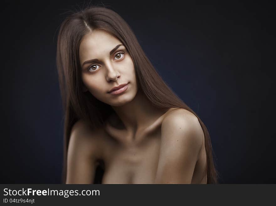 Studio portrait of attractive young woman with long hair. Studio portrait of attractive young woman with long hair