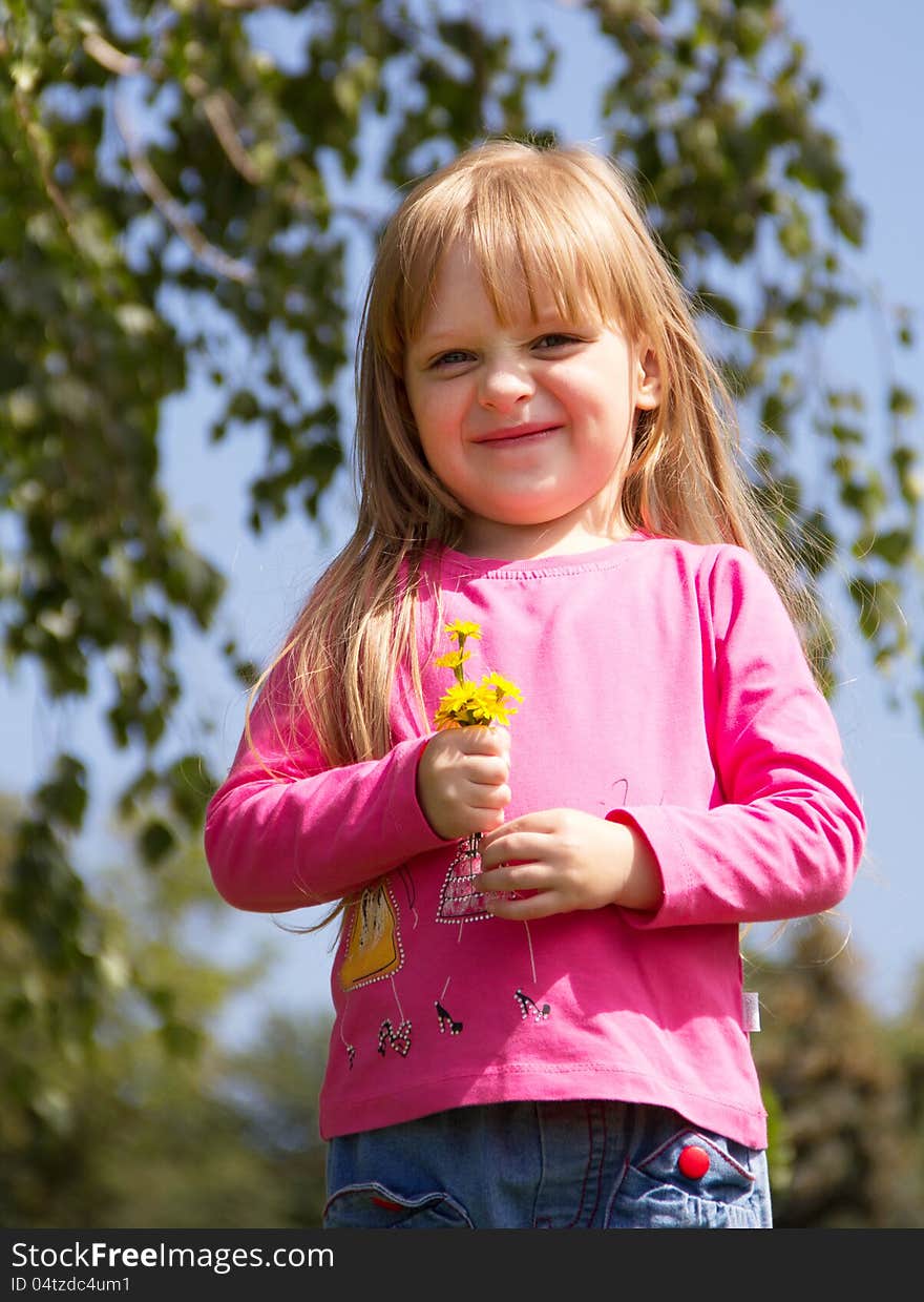 Funny little girl with flowers posing. Close up. Funny little girl with flowers posing. Close up