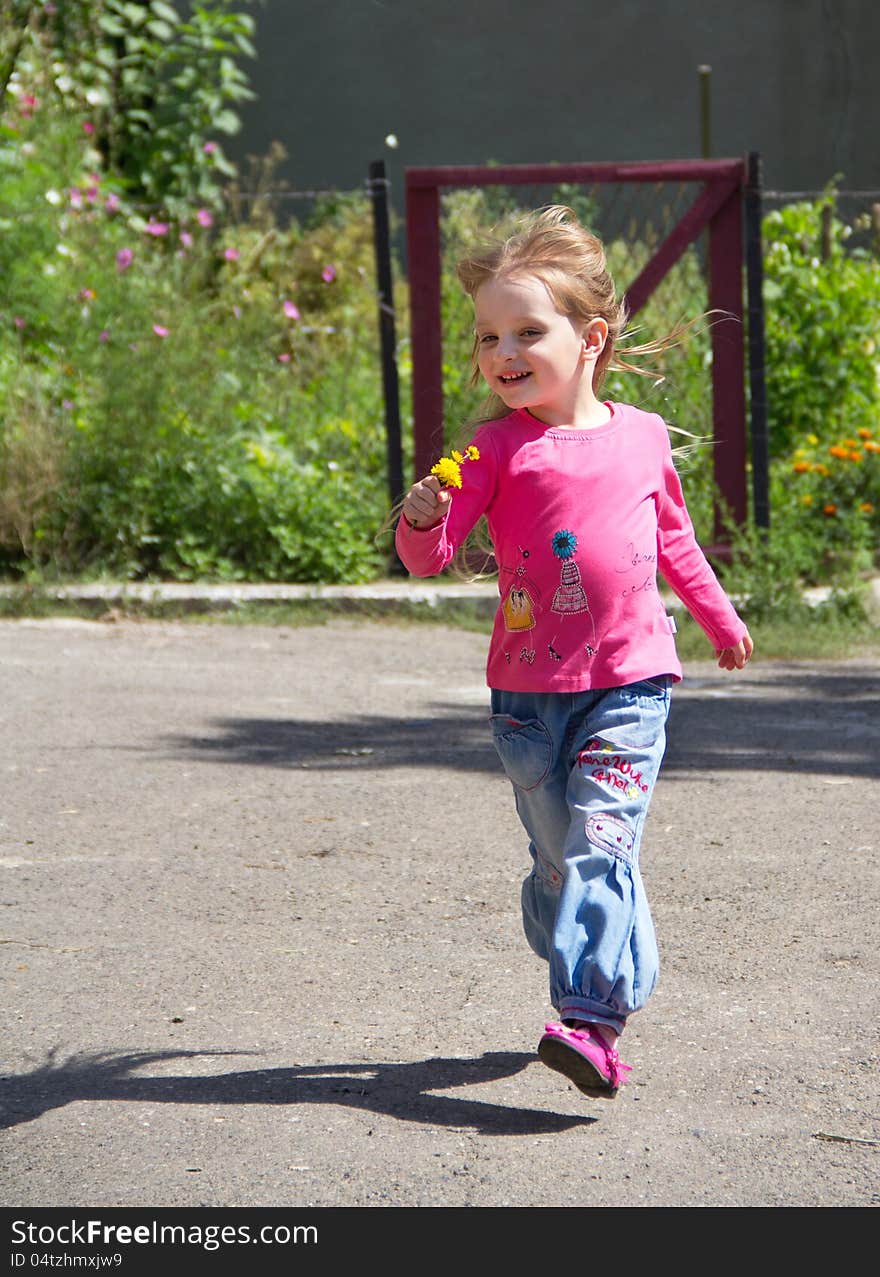 Happy little blond girl running on nature background. Happy little blond girl running on nature background