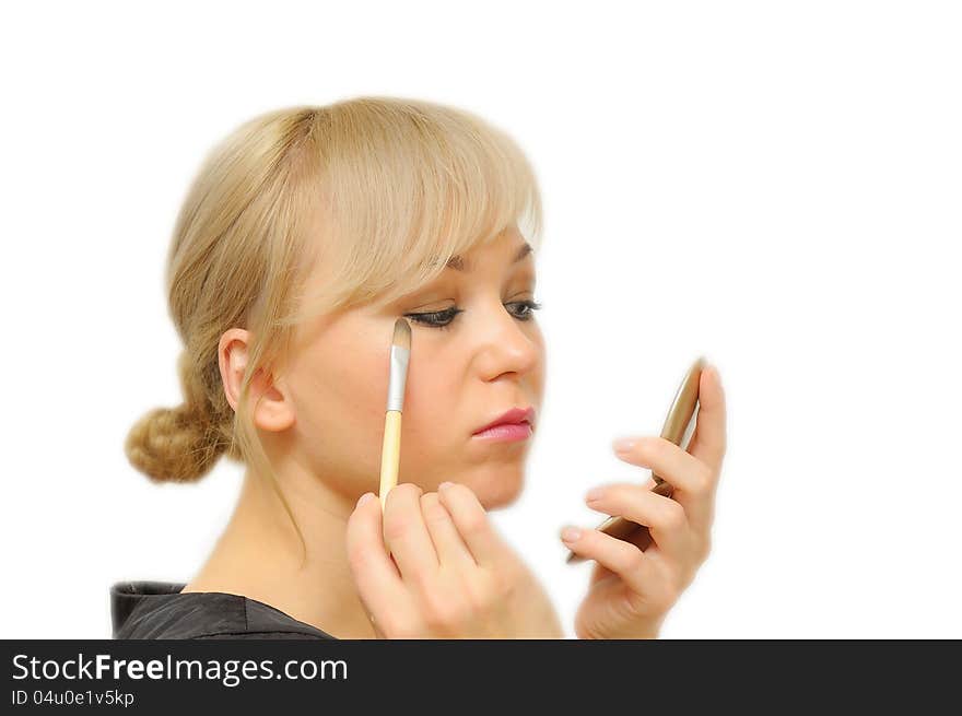 Young beautiful woman with a make-up brush