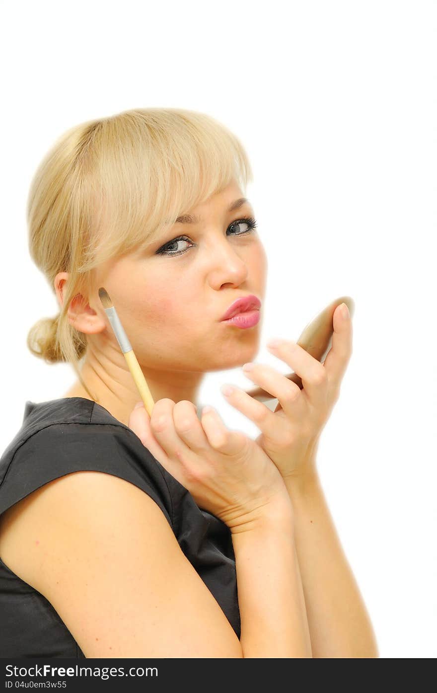 Young beautiful woman with a make-up brush