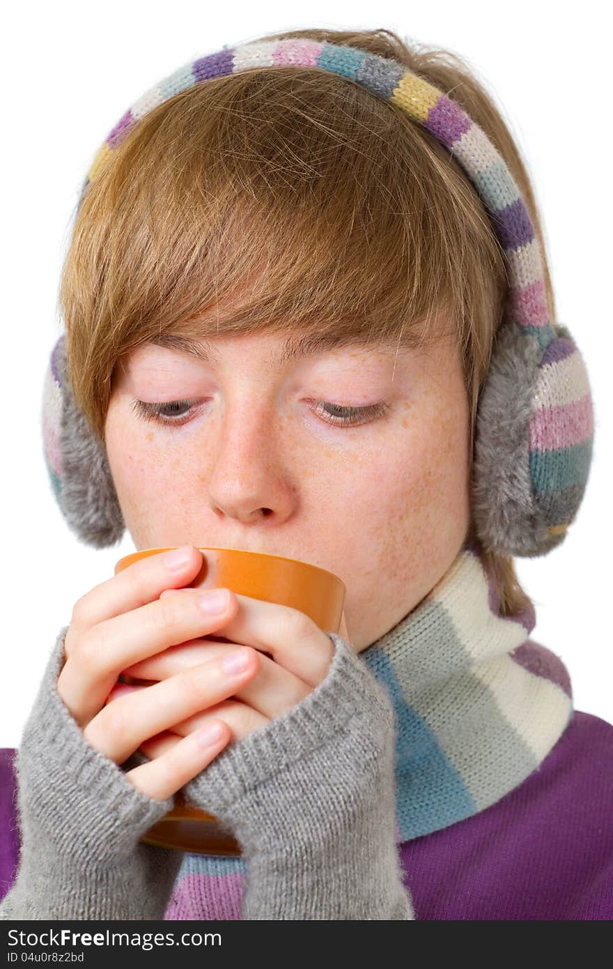 Pretty smiling girl in winter clothes with a cup of hot drink