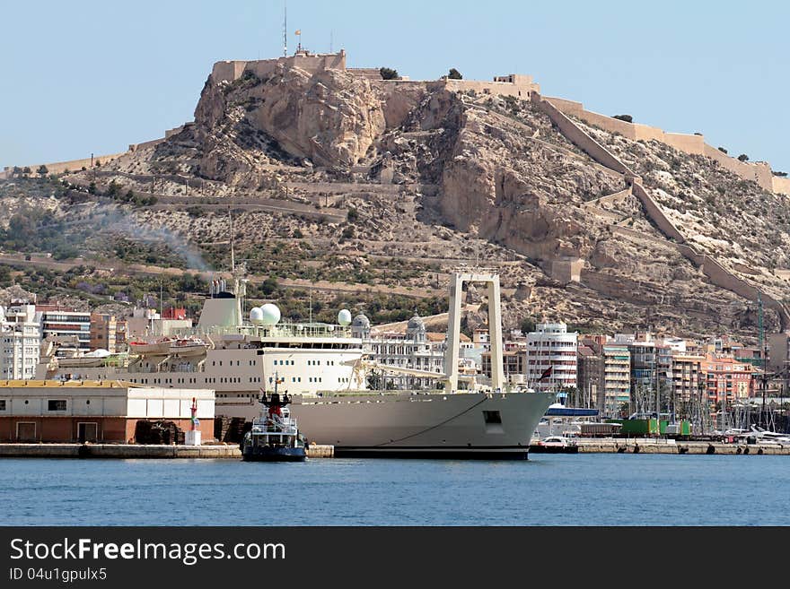 Merchant ship leaving Alicante port helped for tug. Merchant ship leaving Alicante port helped for tug