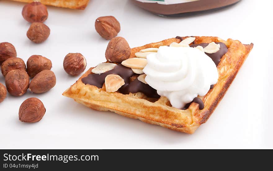 Close Up Of Chocolate Waffles Slice with vanilla cream and nuts