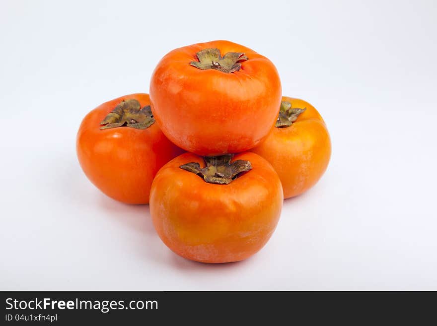 Persimmons  with white background top view. Persimmons  with white background top view