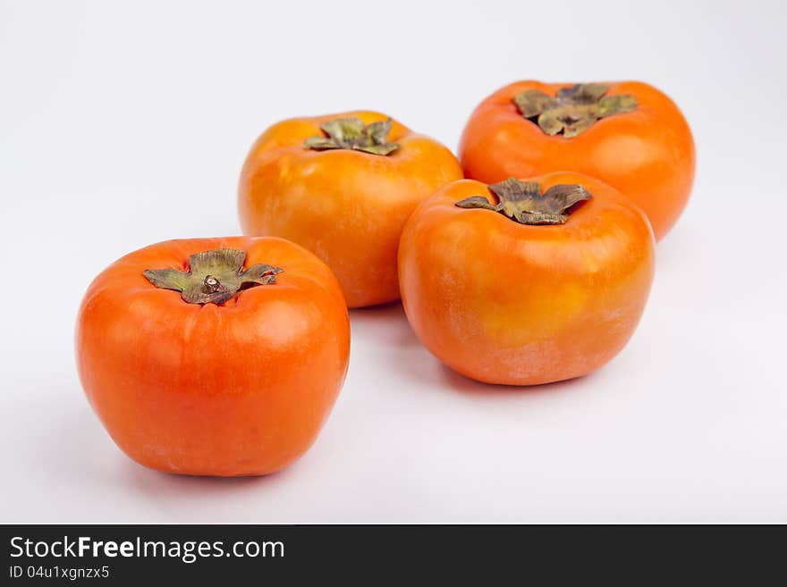 Persimmons  with white background top view. Persimmons  with white background top view