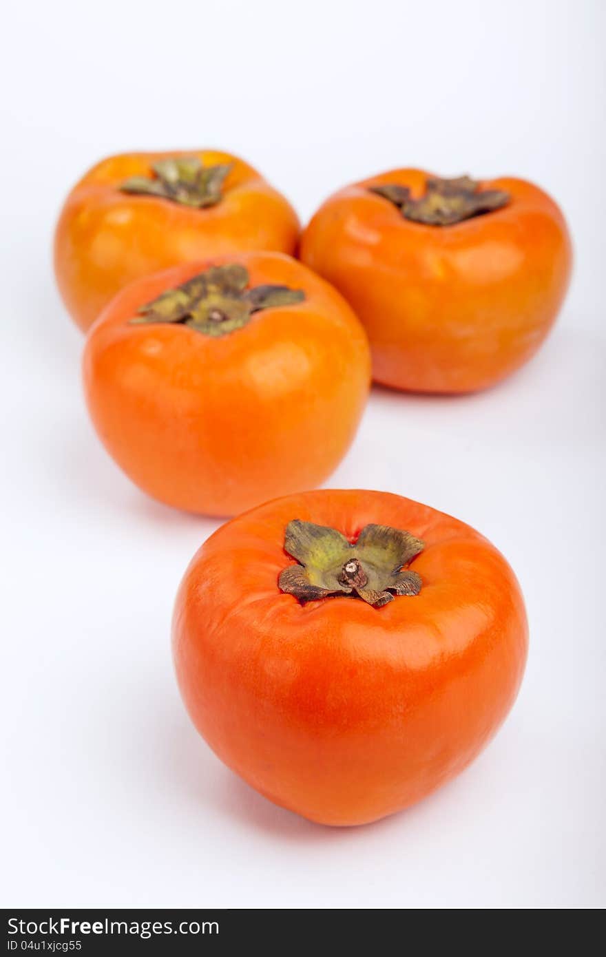 Persimmons  with white background top view. Persimmons  with white background top view