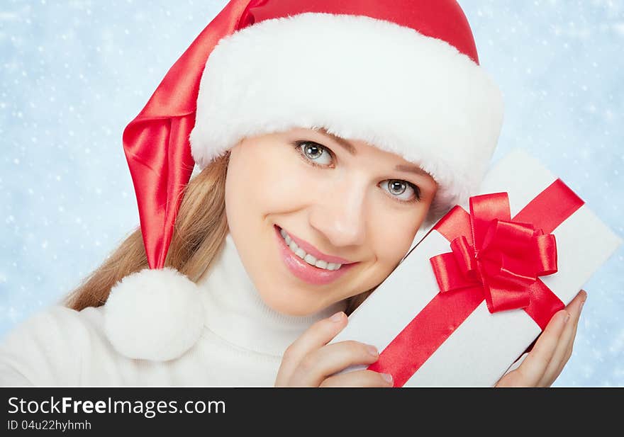 beautiful woman in a Christmas hat with gift