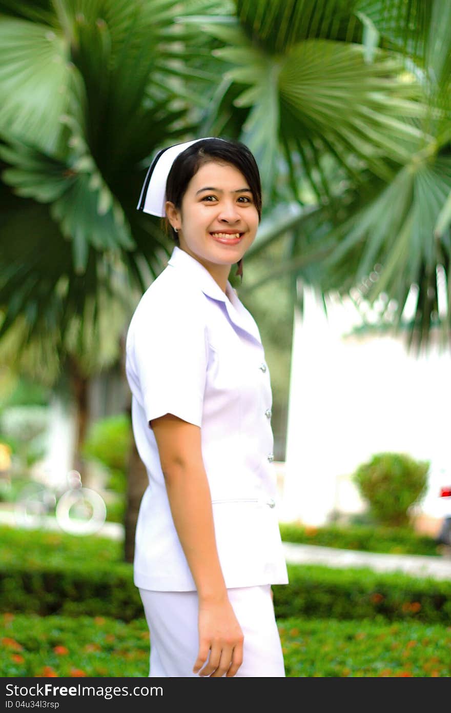 Smiling of Thai nurse on the green background