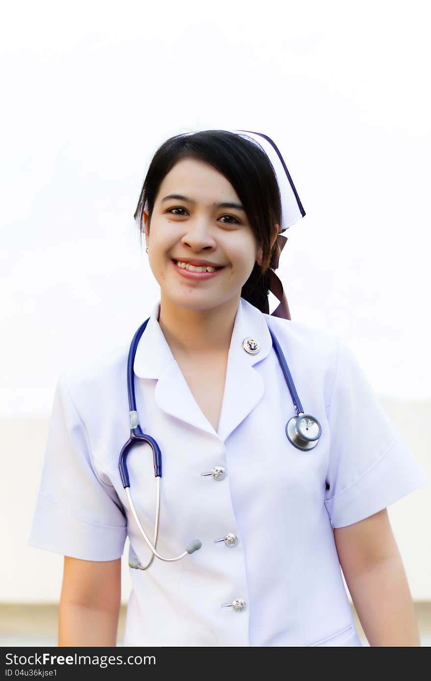 Thai nurse smiling with stethoscope in the garden