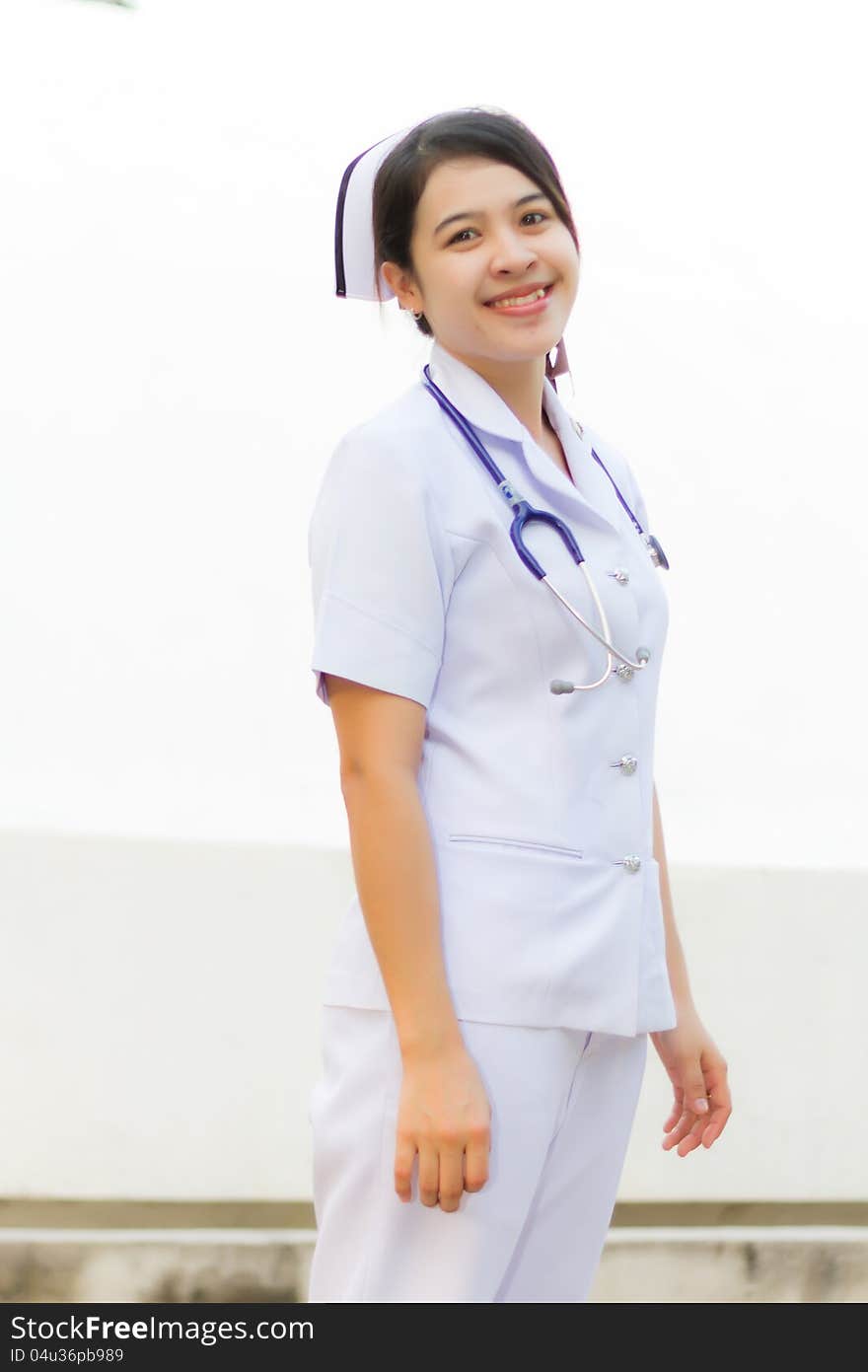 Thai nurse smiling with stethoscope in the garden