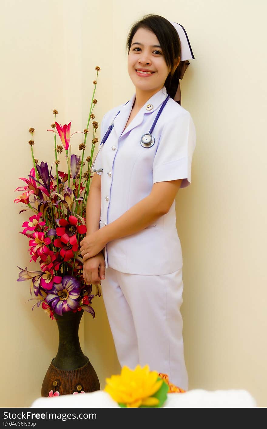 Thai nurse with flower in hospital