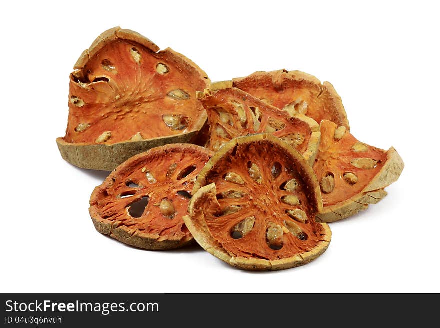 Slices of dried bael fruit on white background