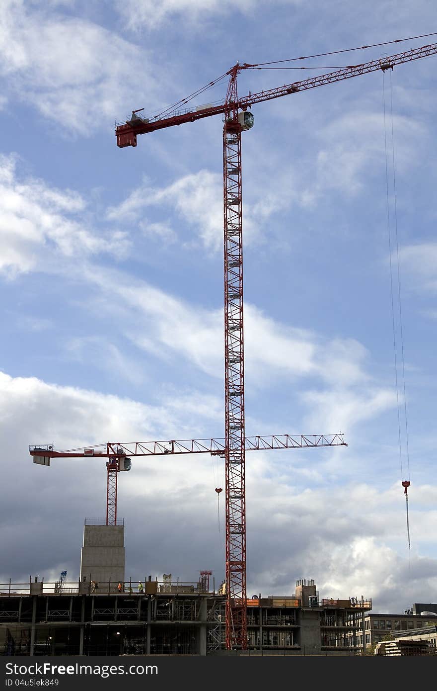 Two cranes used at the same time for the construction of one building.