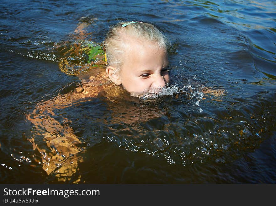 Little Girl Swimming In Lake