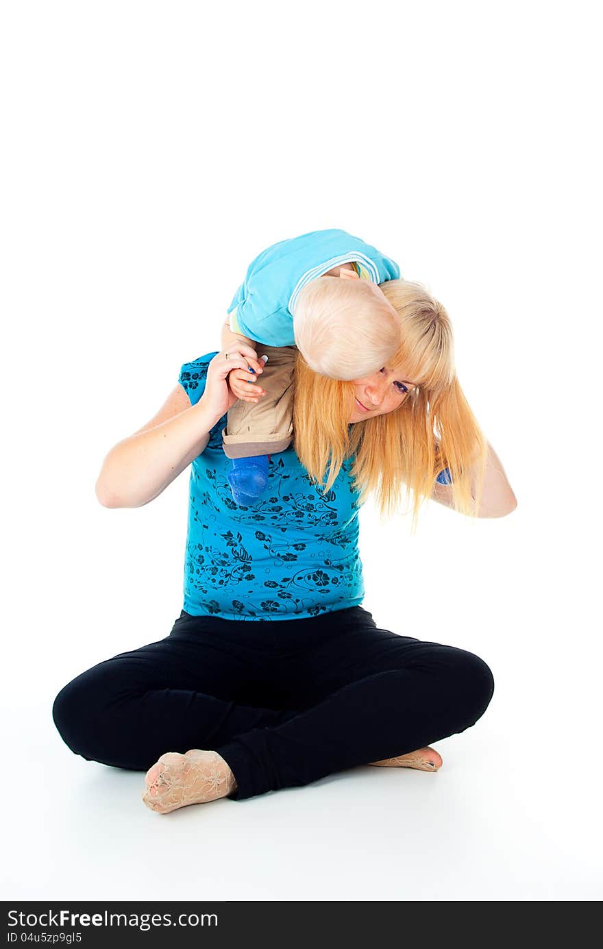 Child Sits On The Shoulders Of Her Mother