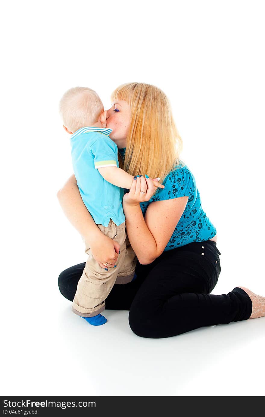 Mother kissing little baby boy