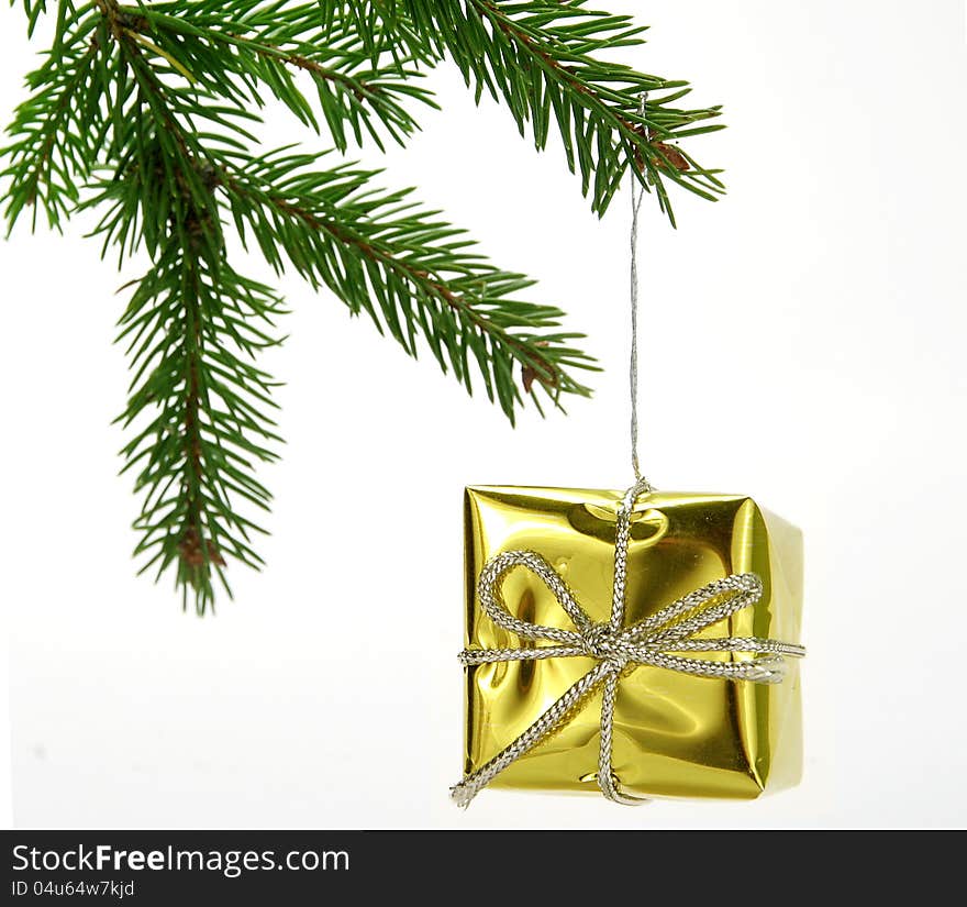 Christmas decoration - Gold gift hanged on twig. Christmas decoration - Gold gift hanged on twig