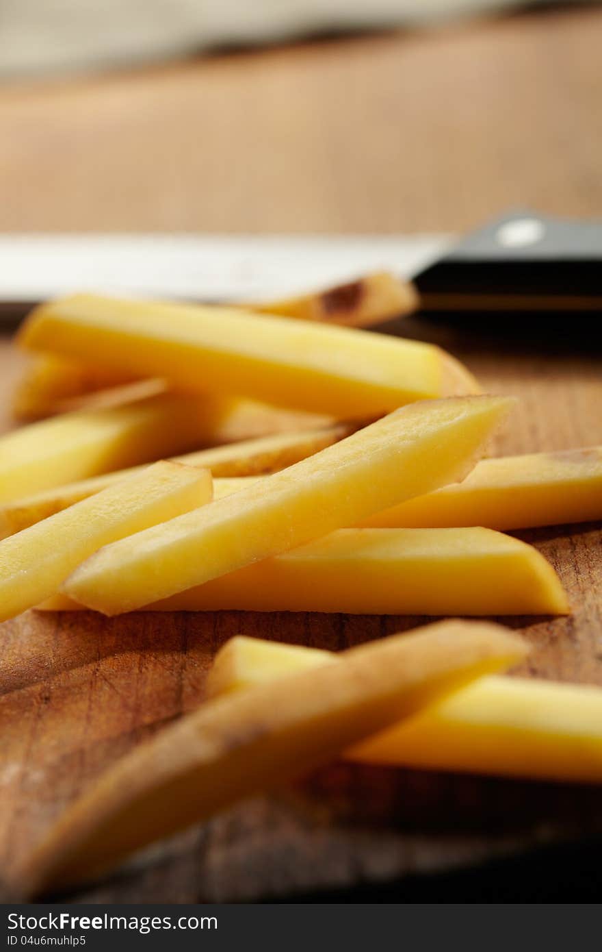 Slicing Potatoes On A Cutting Board