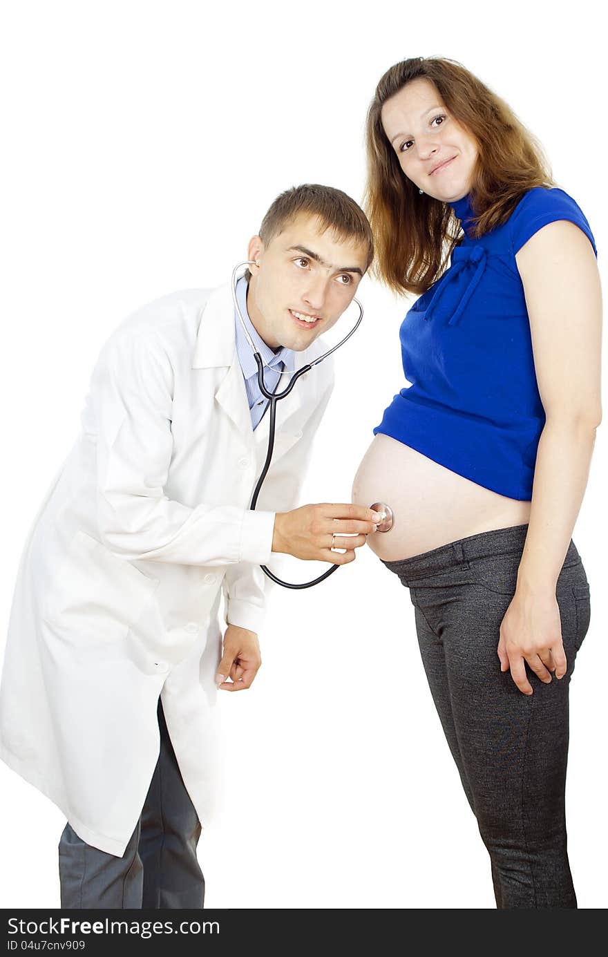 Doctor listening to pregnant woman's belly isolated on white background. Doctor listening to pregnant woman's belly isolated on white background