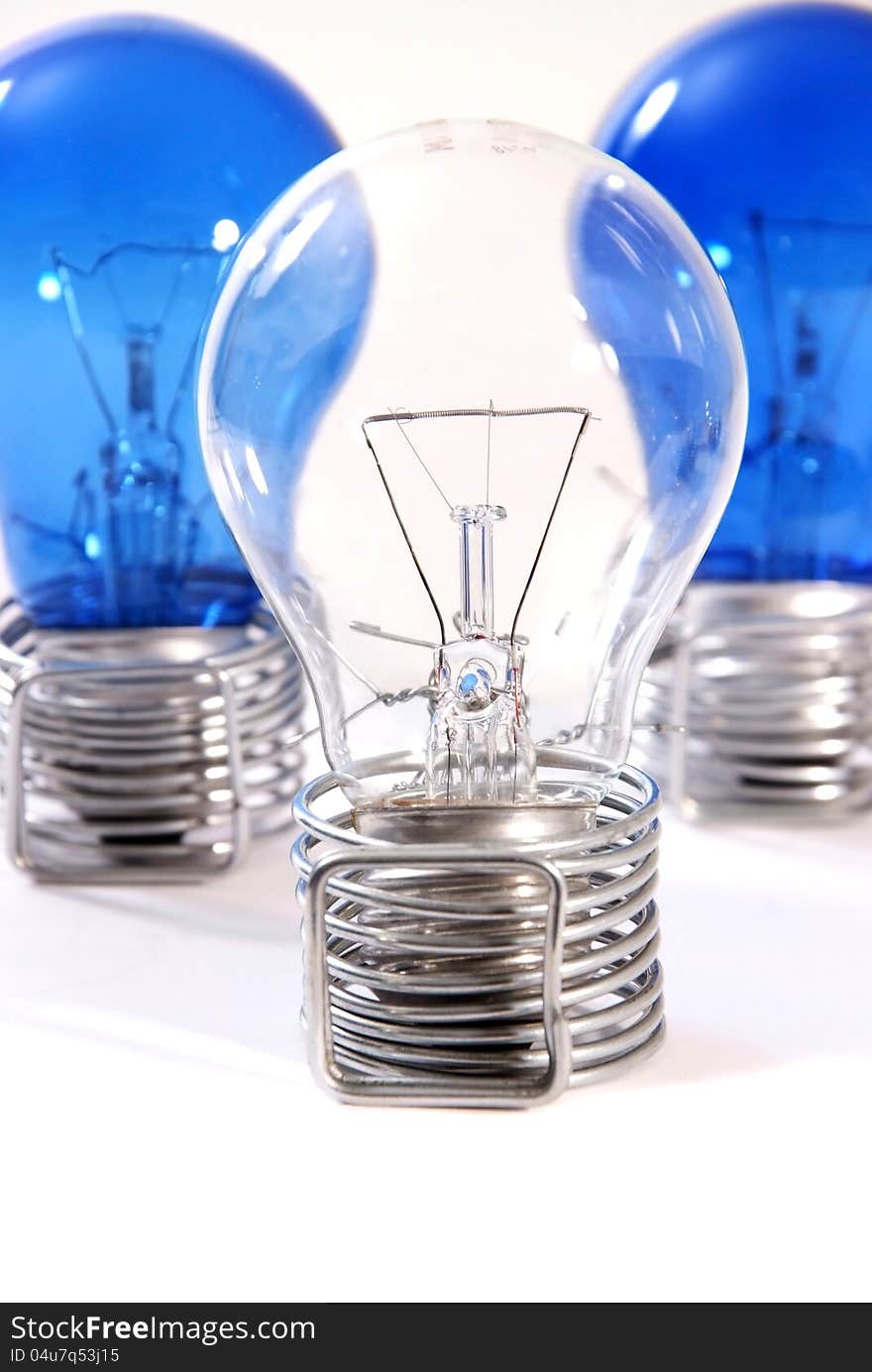 Three bulbs in wire stands on a white background.